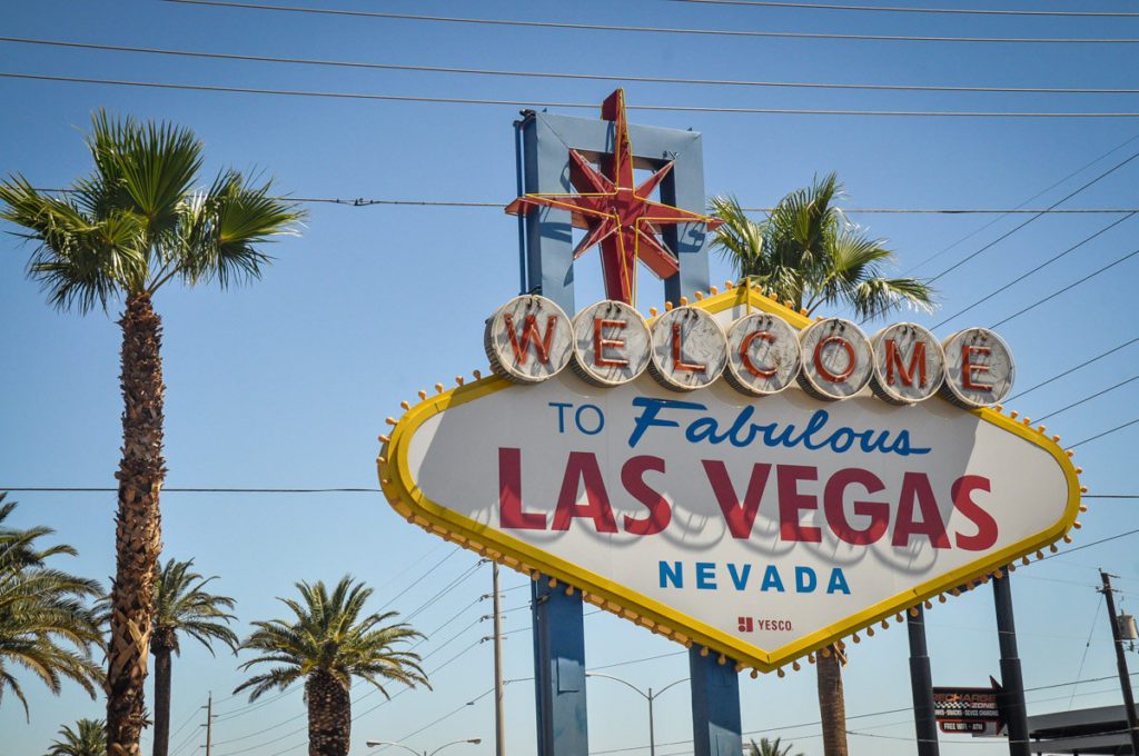 Welcome Sign To Las Vegas With Airplane In The Sky Stock Photo