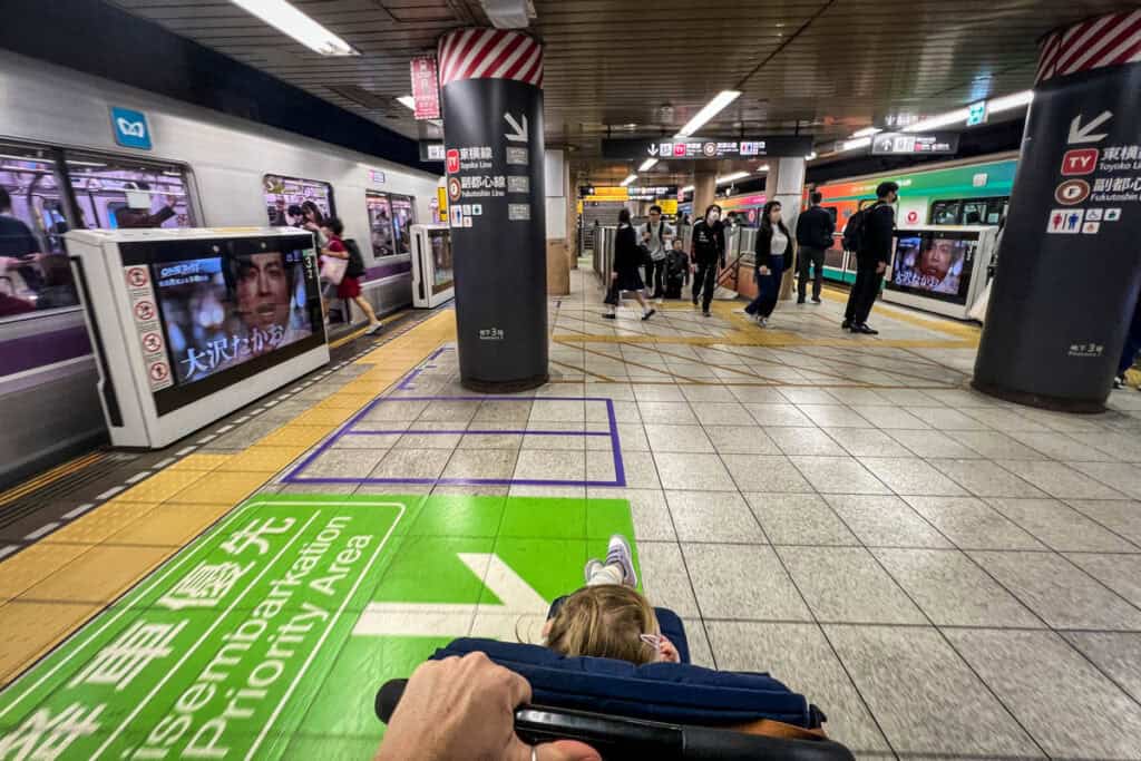 stroller in subway station in Japan with kids