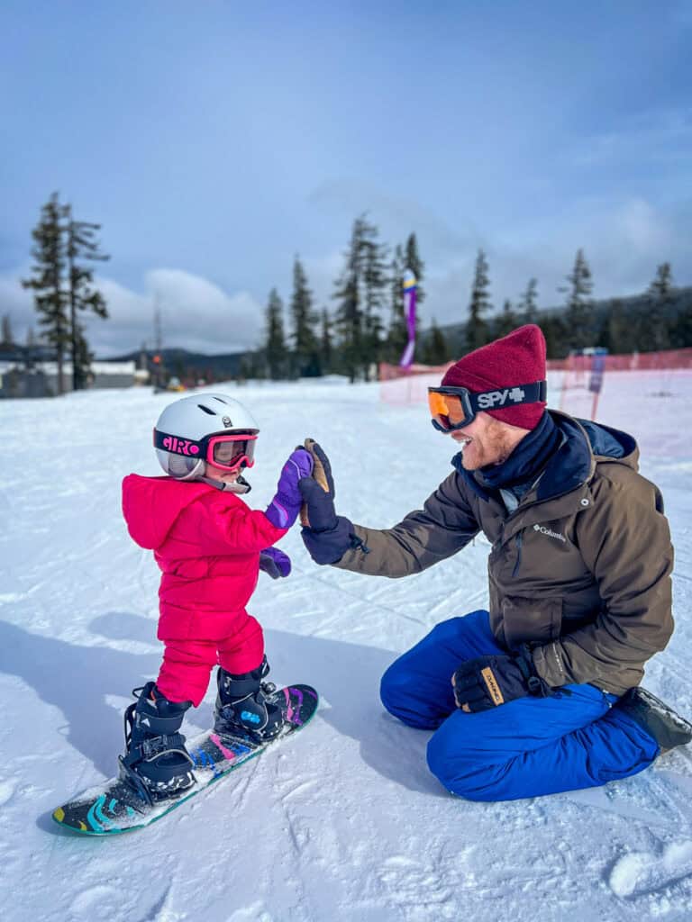 Toddler snowboarding Mount Bachelor